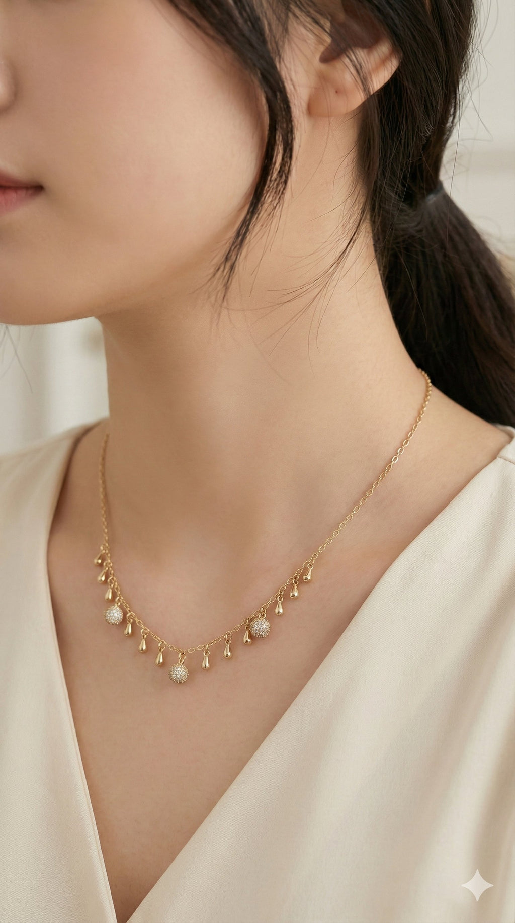 young woman wearing gold-plated hypoallergenic necklace, showing their anti-tarnish shine suitable for sensitive skin and daily wear