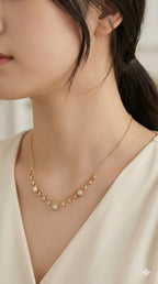 young woman wearing gold-plated hypoallergenic necklace, showing their anti-tarnish shine suitable for sensitive skin and daily wear