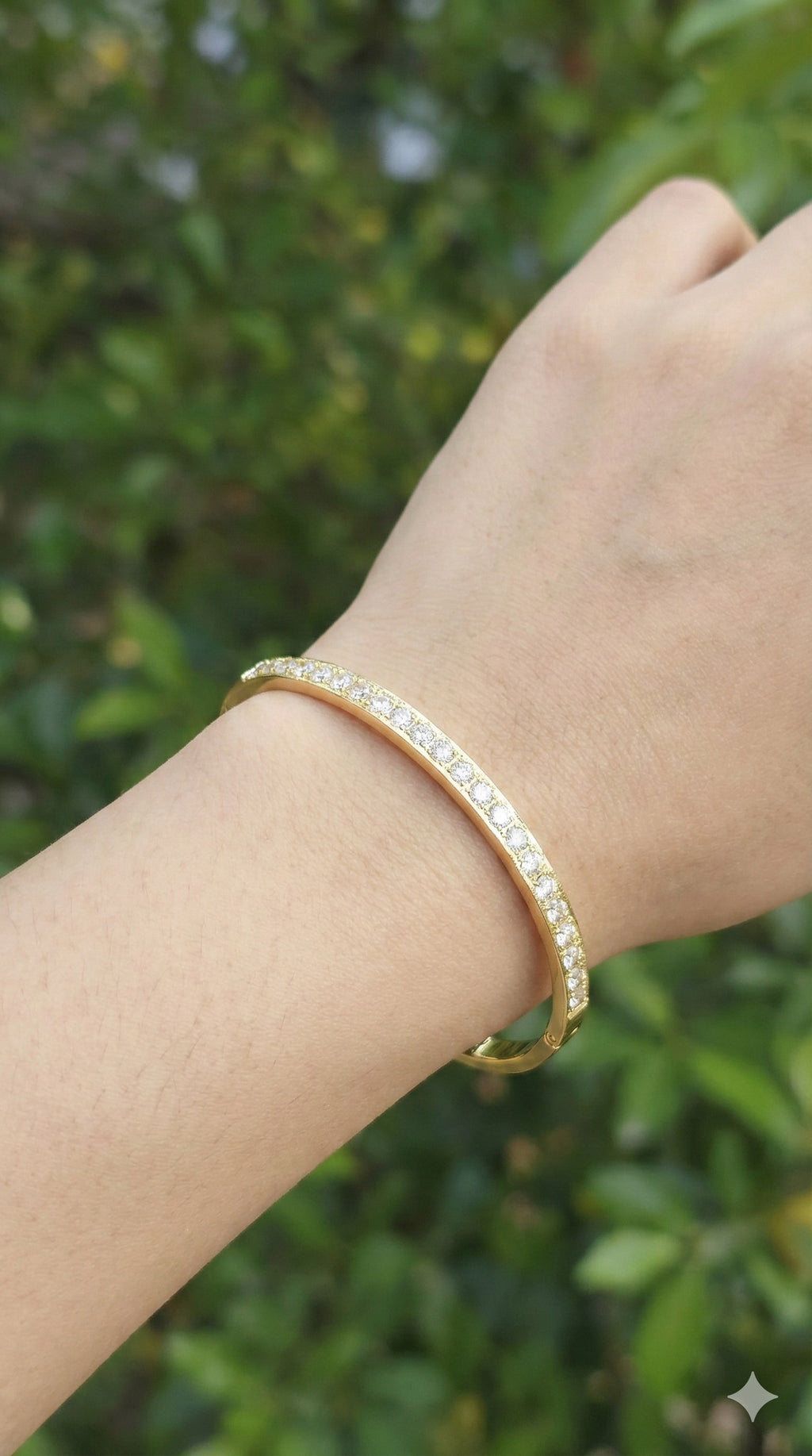 young woman wearing gold-plated hypoallergenic bracelet, showing their anti-tarnish shine suitable for sensitive skin and daily wear