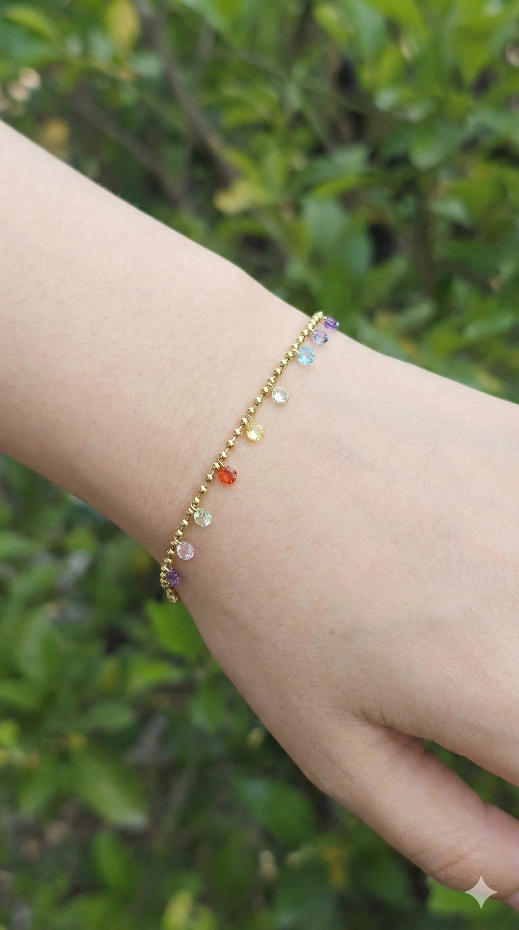 young woman wearing gold-plated hypoallergenic bracelet, showing their anti-tarnish shine suitable for sensitive skin and daily wear