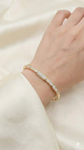young woman wearing gold-plated hypoallergenic bracelet, showing their anti-tarnish shine suitable for sensitive skin and daily wear