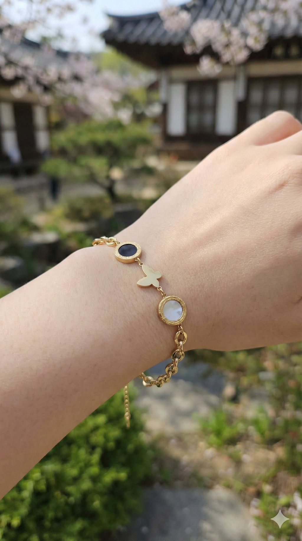 young woman wearing gold-plated hypoallergenic bracelet, showing their anti-tarnish shine suitable for sensitive skin and daily wear