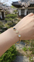 young woman wearing gold-plated hypoallergenic bracelet, showing their anti-tarnish shine suitable for sensitive skin and daily wear