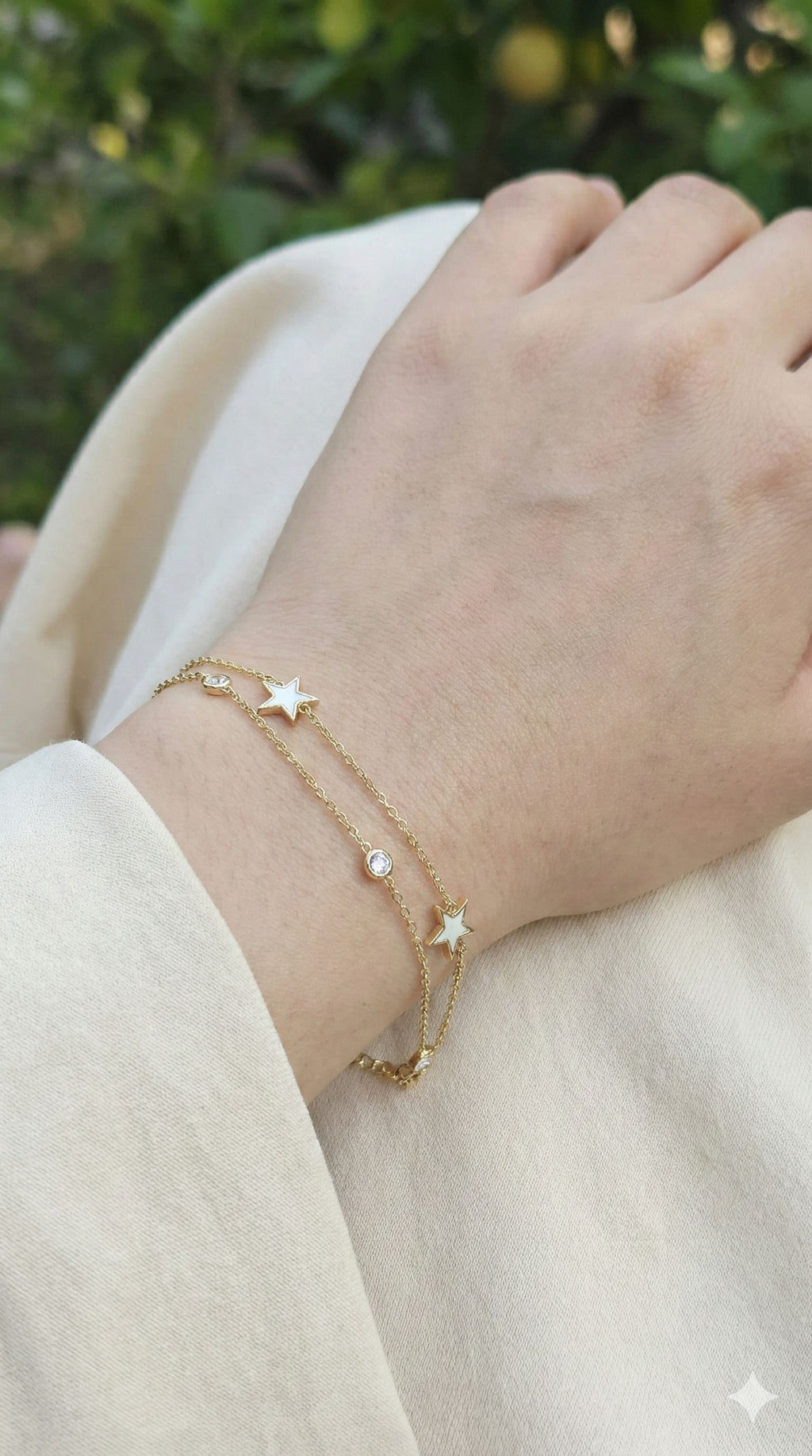young woman wearing gold-plated hypoallergenic bracelet, showing their anti-tarnish shine suitable for sensitive skin and daily wear