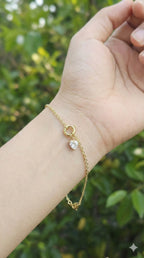 young woman wearing gold-plated hypoallergenic bracelet, showing their anti-tarnish shine suitable for sensitive skin and daily wear