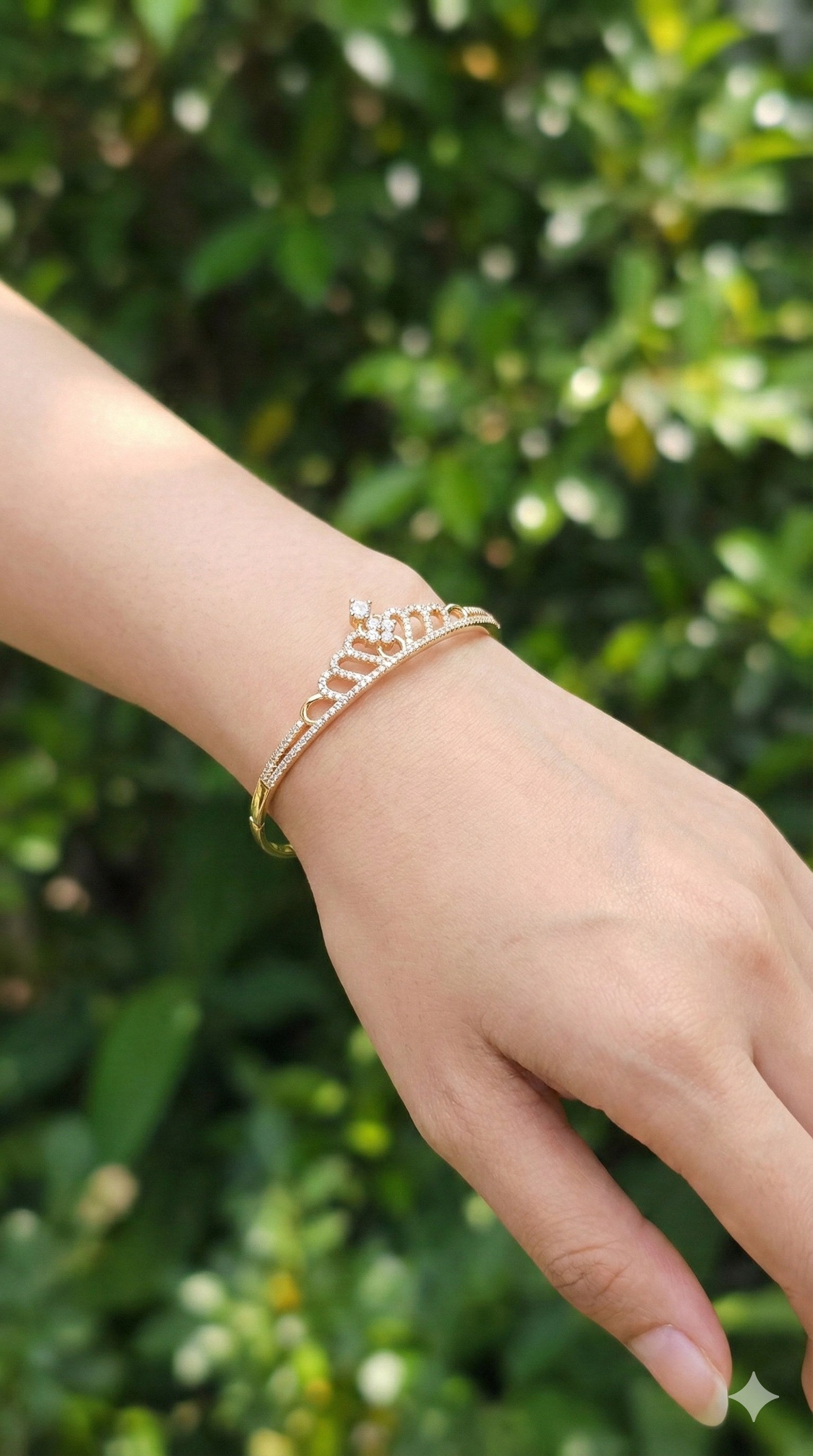 young woman wearing gold-plated hypoallergenic bracelet, showing their anti-tarnish shine suitable for sensitive skin and daily wear