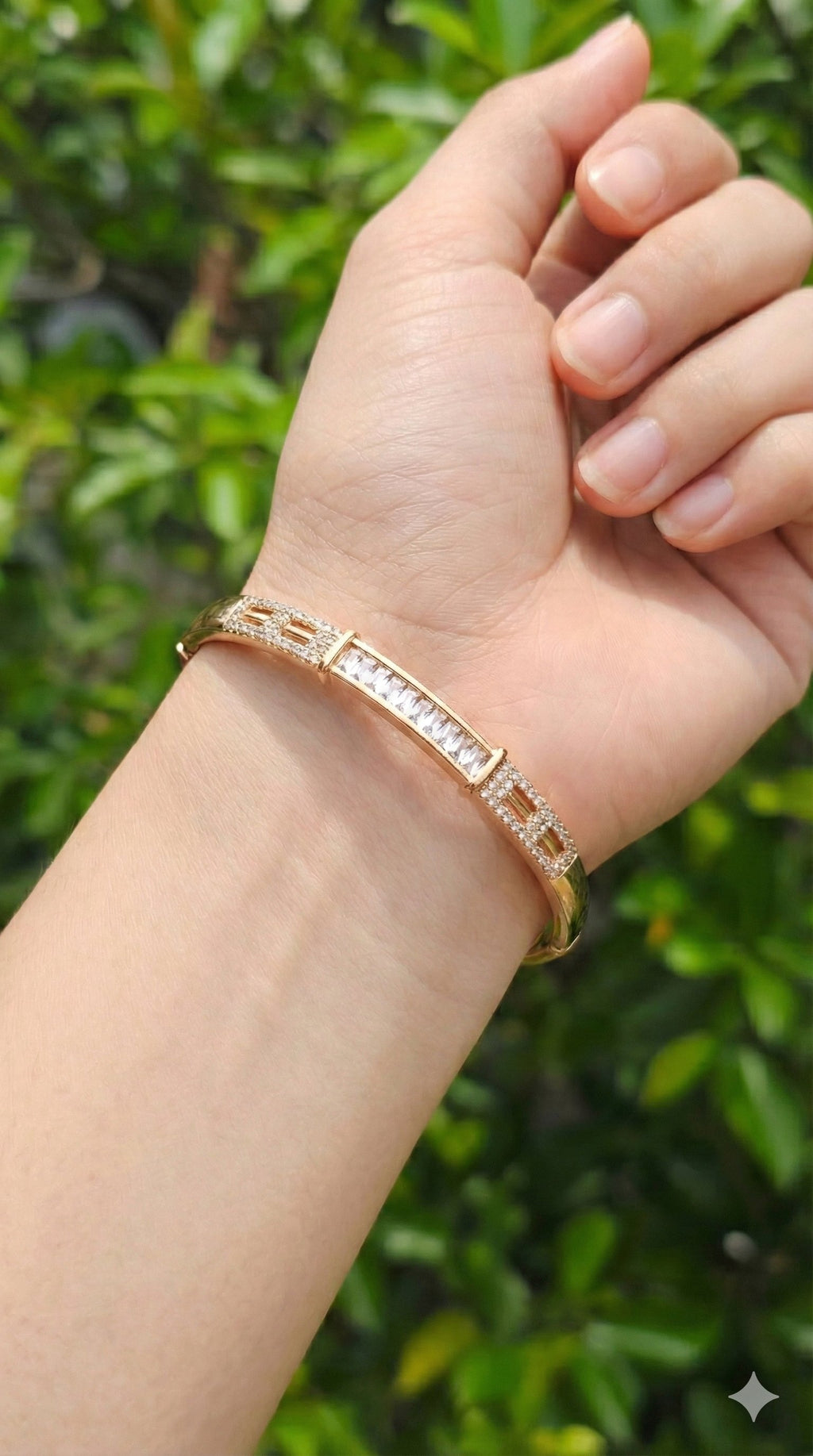 young woman wearing gold-plated hypoallergenic bracelet, showing their anti-tarnish shine suitable for sensitive skin and daily wear