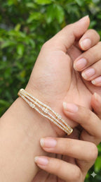 young woman wearing gold-plated hypoallergenic bracelet, showing their anti-tarnish shine suitable for sensitive skin and daily wear