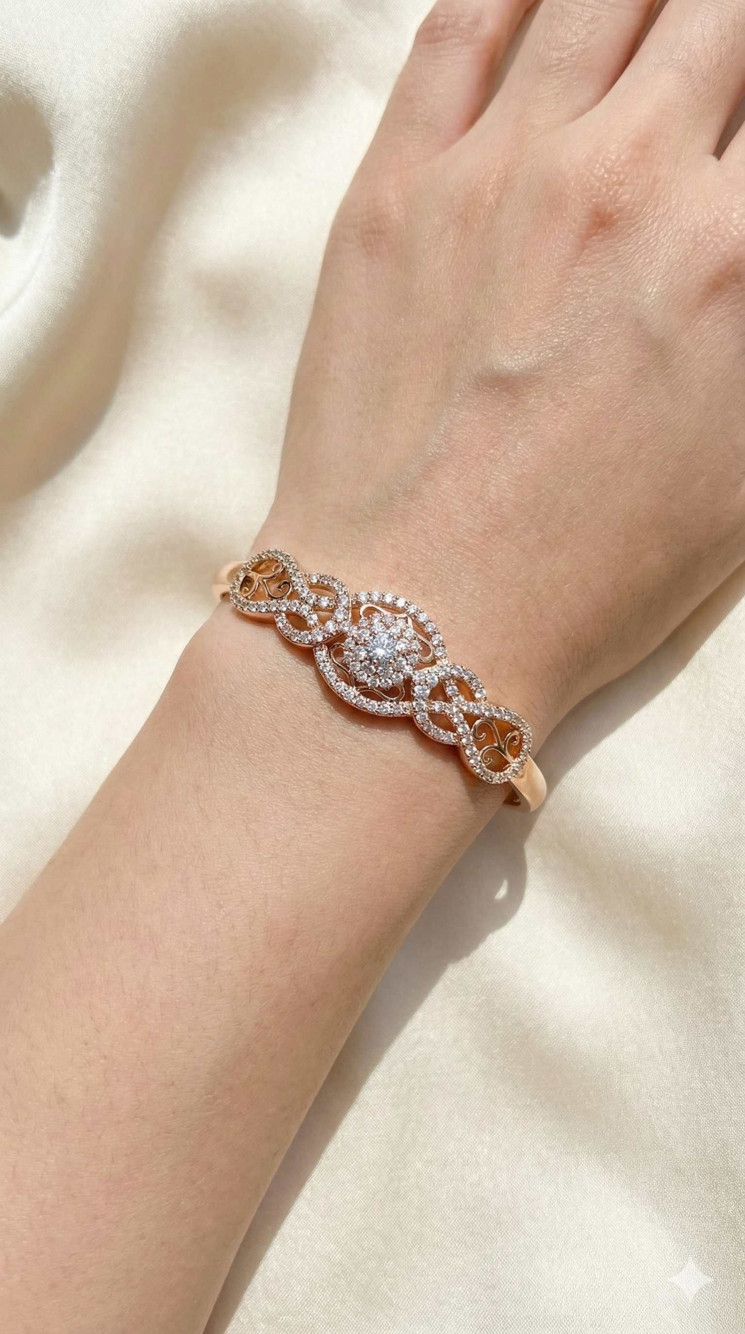 young woman wearing gold-plated hypoallergenic bracelet, showing their anti-tarnish shine suitable for sensitive skin and daily wear