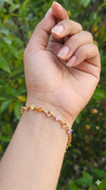 young woman wearing gold-plated hypoallergenic bracelet, showing their anti-tarnish shine suitable for sensitive skin and daily wear