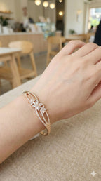 young woman wearing gold-plated hypoallergenic bracelet, showing their anti-tarnish shine suitable for sensitive skin and daily wear