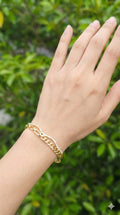 young woman wearing gold-plated hypoallergenic bracelet, showing their anti-tarnish shine suitable for sensitive skin and daily wear