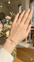 young woman wearing gold-plated hypoallergenic bracelet, showing their anti-tarnish shine suitable for sensitive skin and daily wear