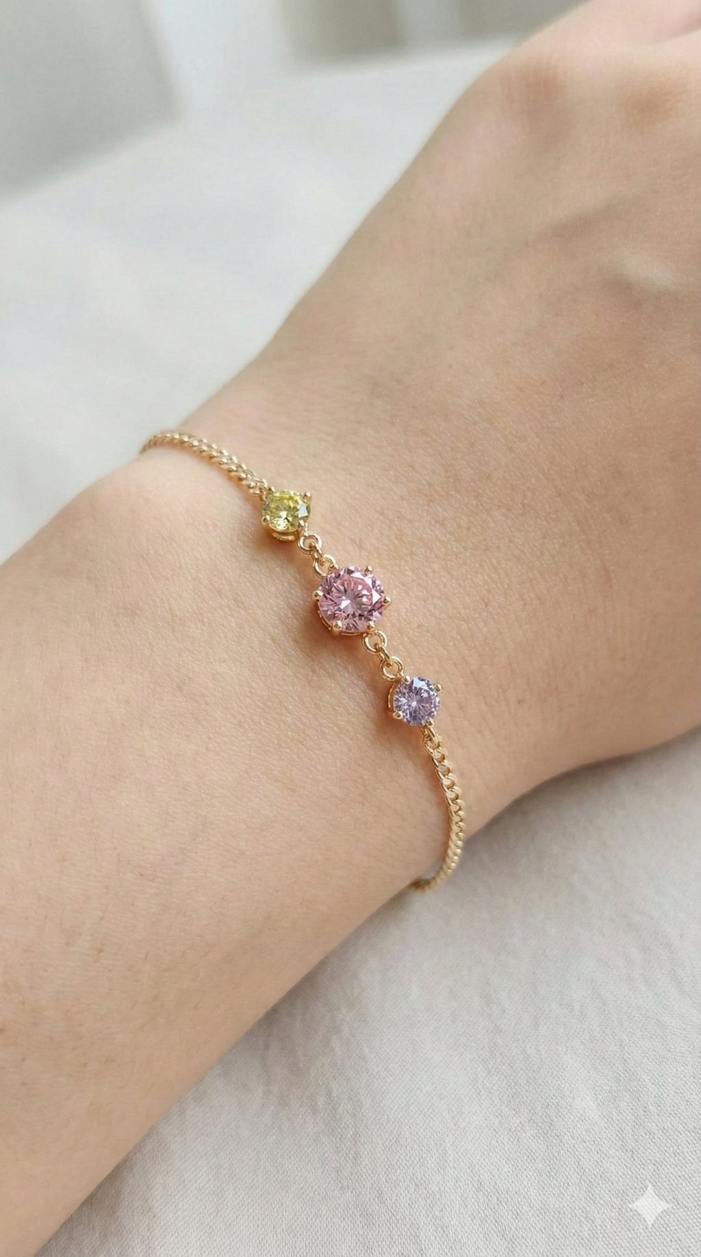 young woman wearing gold-plated hypoallergenic bracelet, showing their anti-tarnish shine suitable for sensitive skin and daily wear