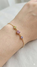 young woman wearing gold-plated hypoallergenic bracelet, showing their anti-tarnish shine suitable for sensitive skin and daily wear