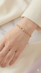 young woman wearing gold-plated hypoallergenic bracelet, showing their anti-tarnish shine suitable for sensitive skin and daily wear