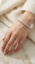 young woman wearing gold-plated hypoallergenic bracelet, showing their anti-tarnish shine suitable for sensitive skin and daily wear