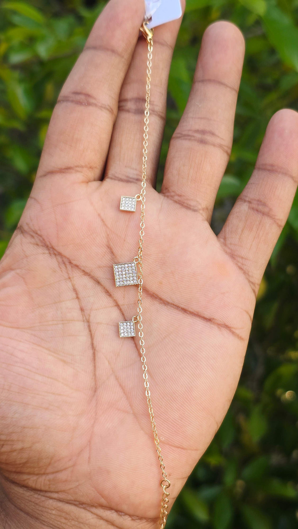 young woman wearing gold-plated hypoallergenic bracelet, showing their anti-tarnish shine suitable for sensitive skin and daily wear