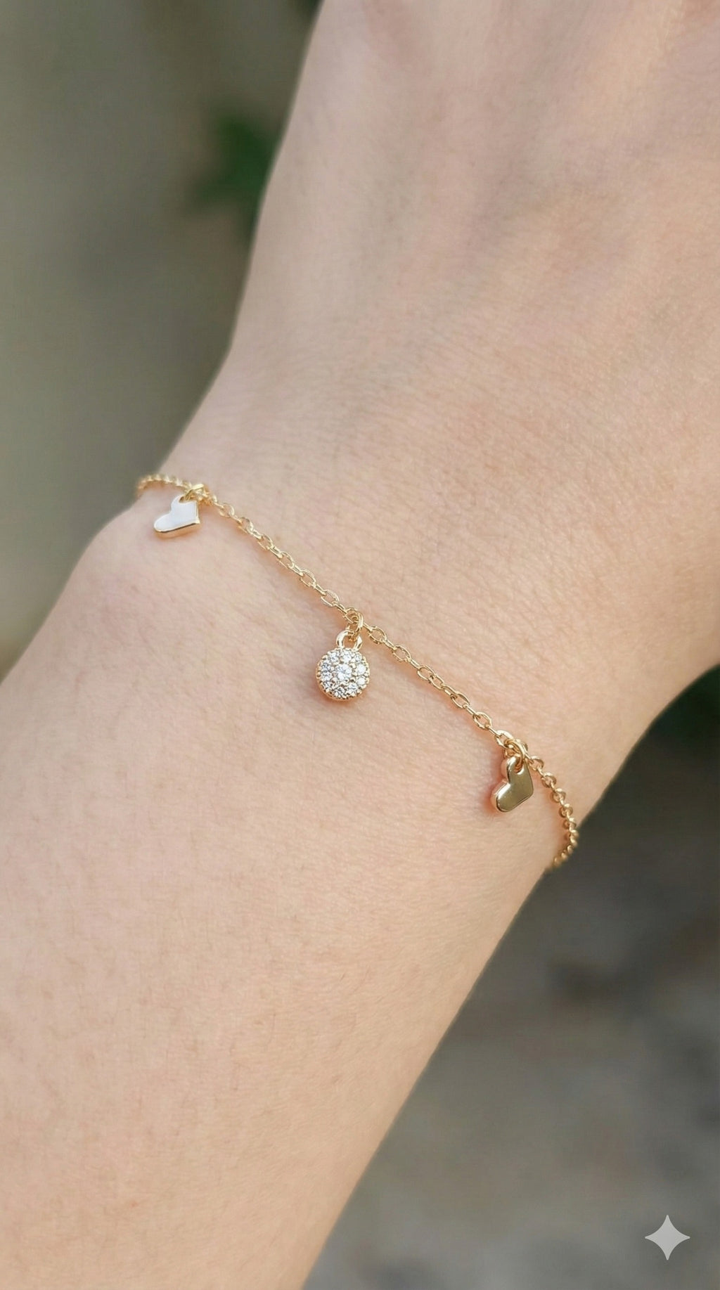 young woman wearing gold-plated hypoallergenic bracelet, showing their anti-tarnish shine suitable for sensitive skin and daily wear
