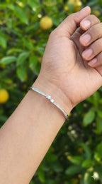 young woman wearing gold-plated hypoallergenic bracelet, showing their anti-tarnish shine suitable for sensitive skin and daily wear