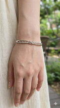 young woman wearing gold-plated hypoallergenic bracelet, showing their anti-tarnish shine suitable for sensitive skin and daily wear