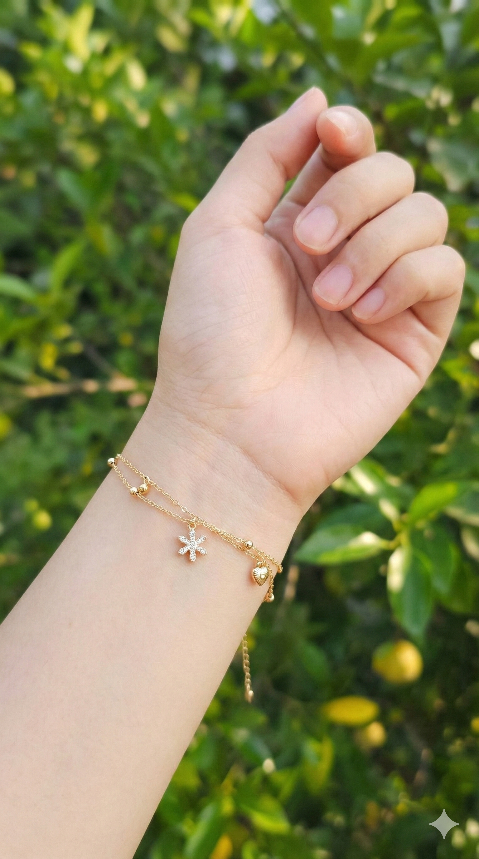 young woman wearing gold-plated hypoallergenic bracelet, showing their anti-tarnish shine suitable for sensitive skin and daily wear
