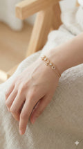 young woman wearing gold-plated hypoallergenic bracelet, showing their anti-tarnish shine suitable for sensitive skin and daily wear