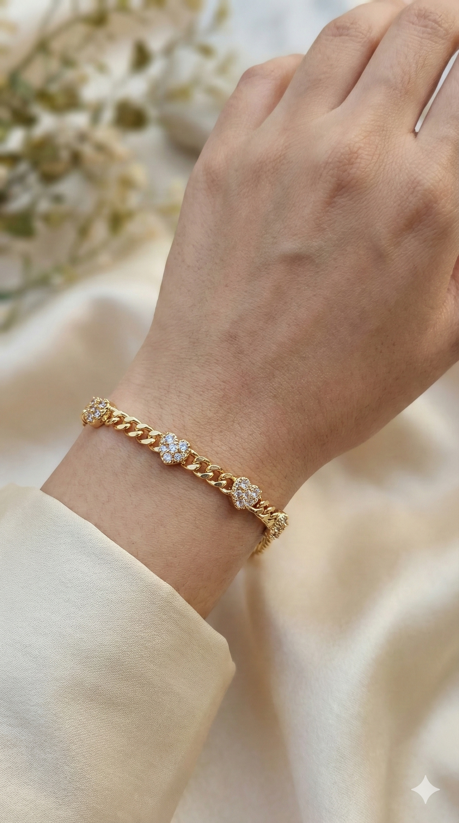 young woman wearing gold-plated hypoallergenic bracelet, showing their anti-tarnish shine suitable for sensitive skin and daily wear
