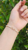young woman wearing gold-plated hypoallergenic bracelet, showing their anti-tarnish shine suitable for sensitive skin and daily wear
