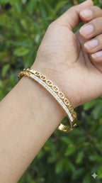 young woman wearing gold-plated hypoallergenic bracelet, showing their anti-tarnish shine suitable for sensitive skin and daily wear