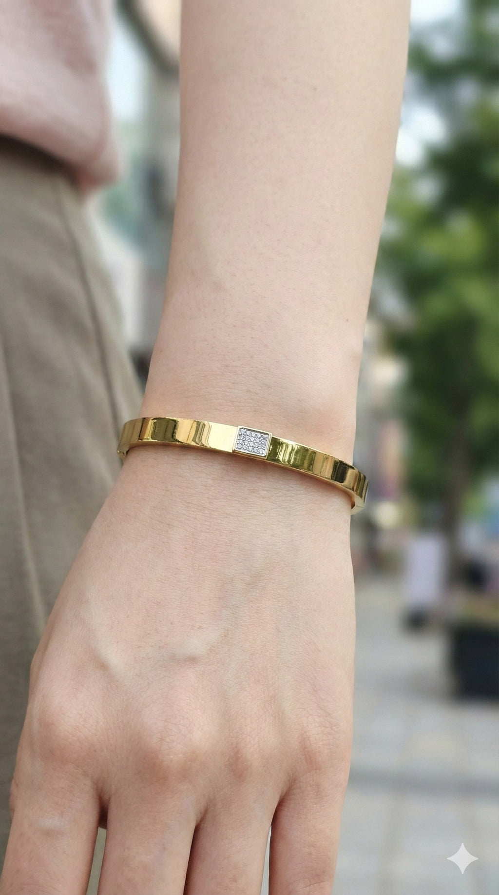 young woman wearing gold-plated hypoallergenic bracelet, showing their anti-tarnish shine suitable for sensitive skin and daily wear