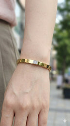 young woman wearing gold-plated hypoallergenic bracelet, showing their anti-tarnish shine suitable for sensitive skin and daily wear