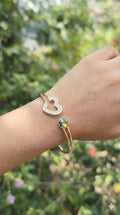 young woman wearing gold-plated hypoallergenic bracelet, showing their anti-tarnish shine suitable for sensitive skin and daily wear