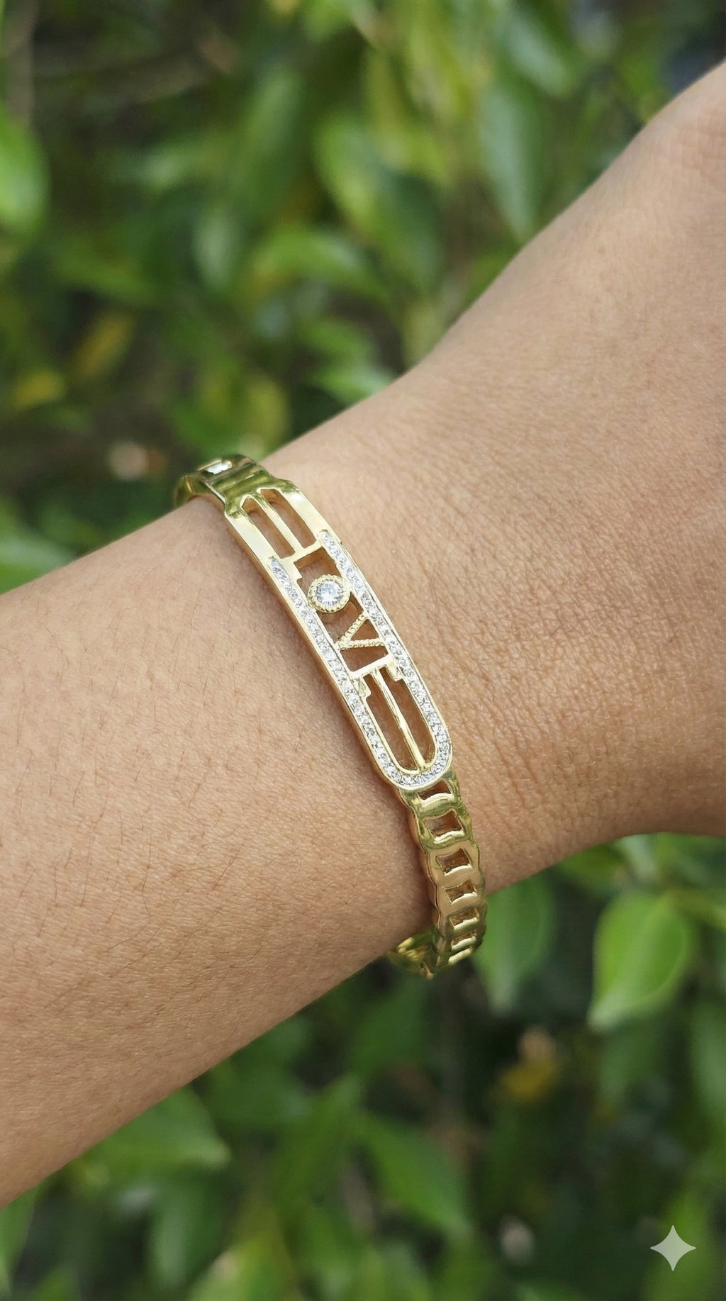 young woman wearing gold-plated hypoallergenic bracelet, showing their anti-tarnish shine suitable for sensitive skin and daily wear