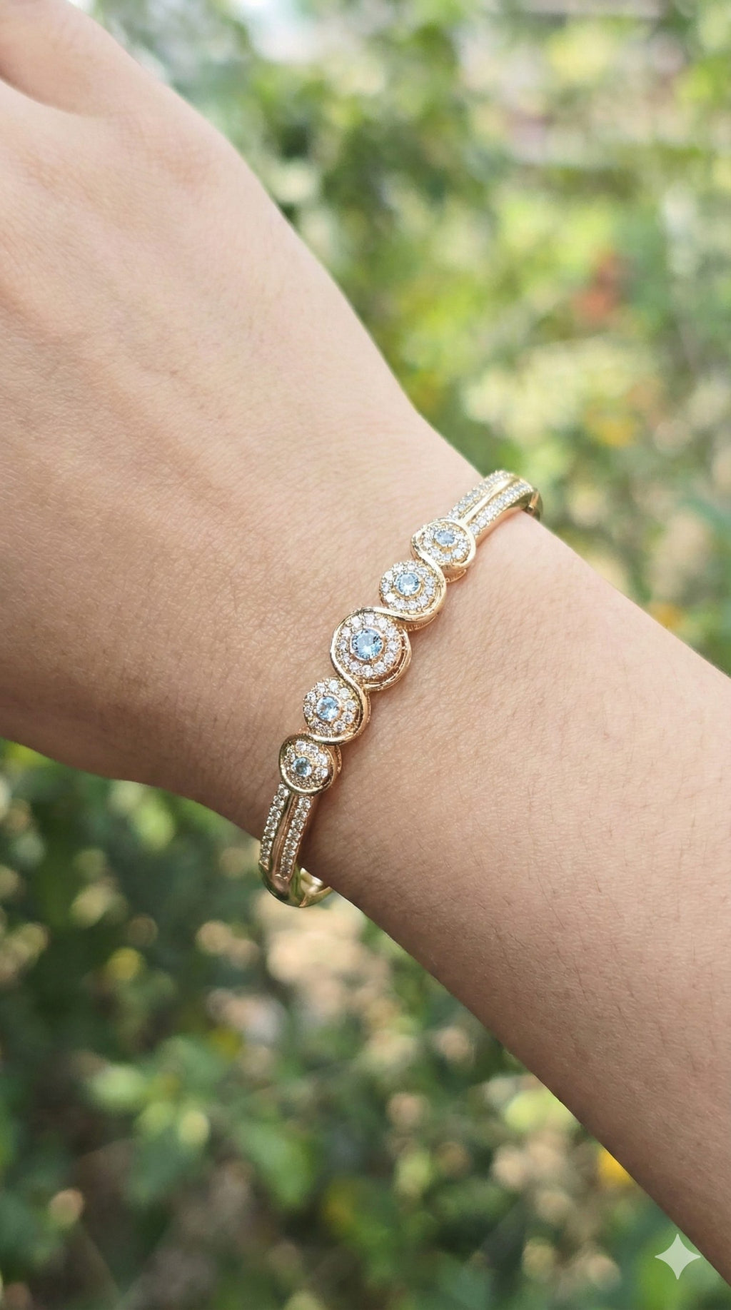 young woman wearing gold-plated hypoallergenic bracelet, showing their anti-tarnish shine suitable for sensitive skin and daily wear