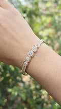 young woman wearing gold-plated hypoallergenic bracelet, showing their anti-tarnish shine suitable for sensitive skin and daily wear