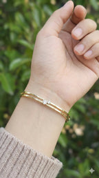 young woman wearing gold-plated hypoallergenic bracelet, showing their anti-tarnish shine suitable for sensitive skin and daily wear
