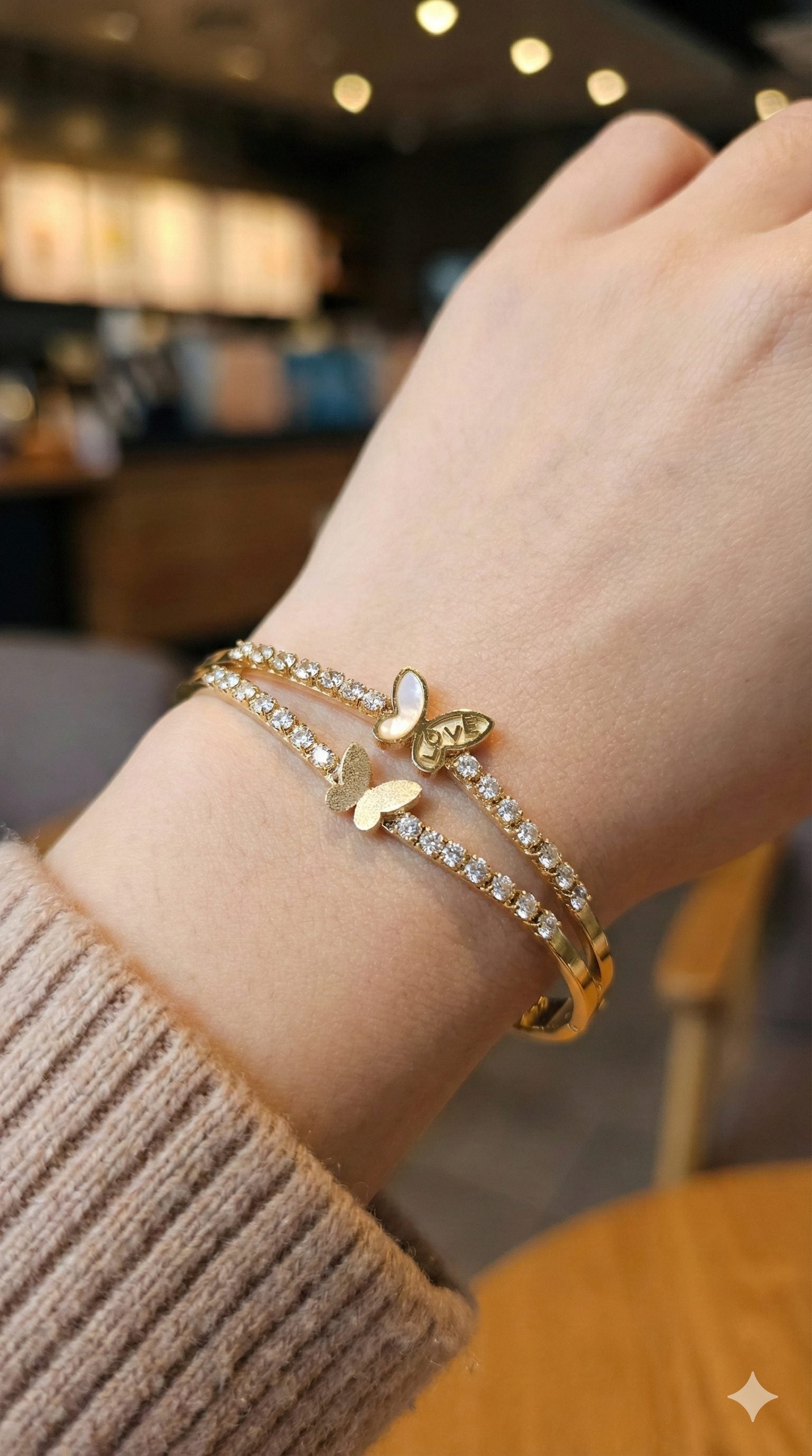 young woman wearing gold-plated hypoallergenic bracelet, showing their anti-tarnish shine suitable for sensitive skin and daily wear
