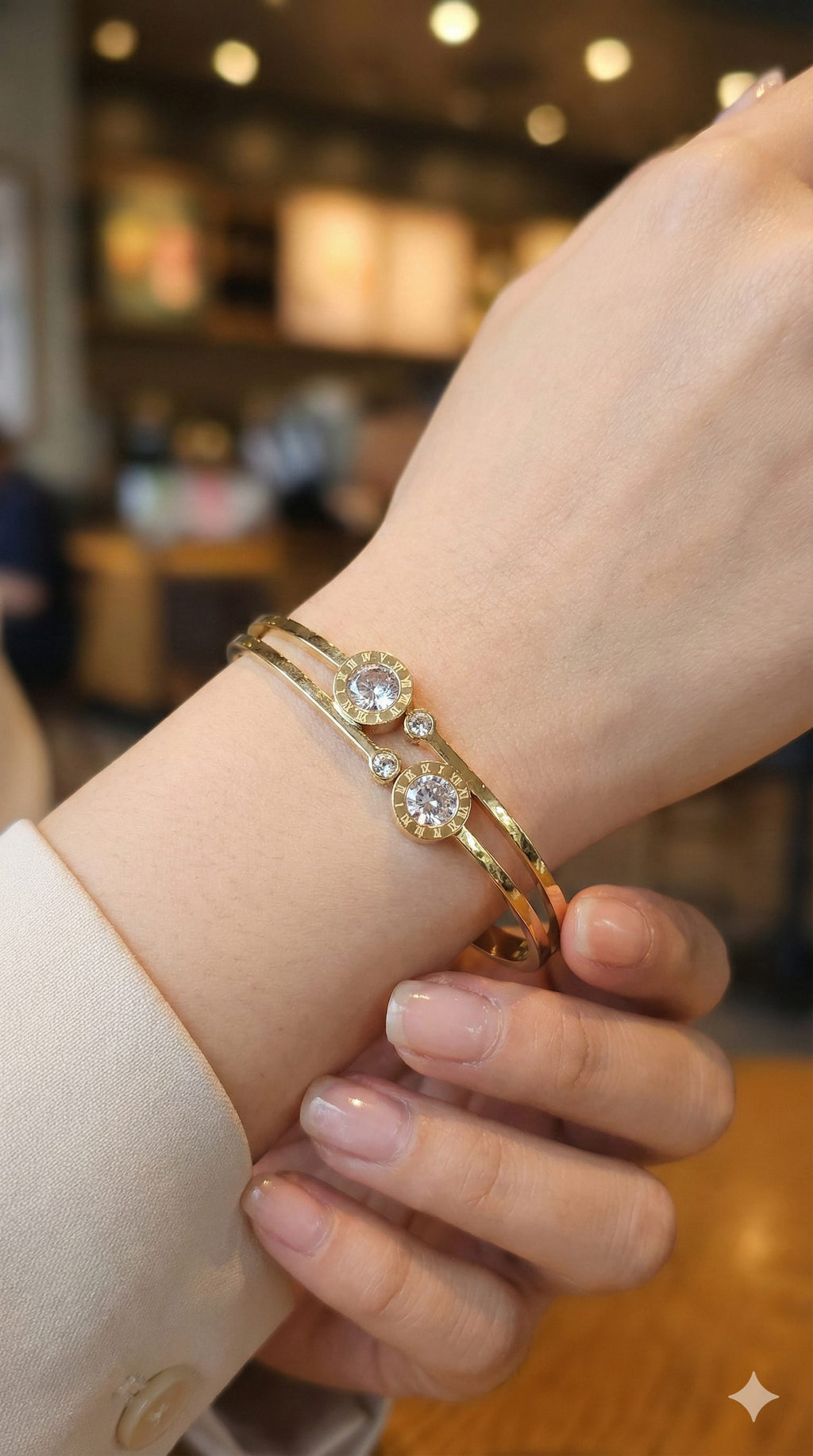 young woman wearing gold-plated hypoallergenic bracelet, showing their anti-tarnish shine suitable for sensitive skin and daily wear