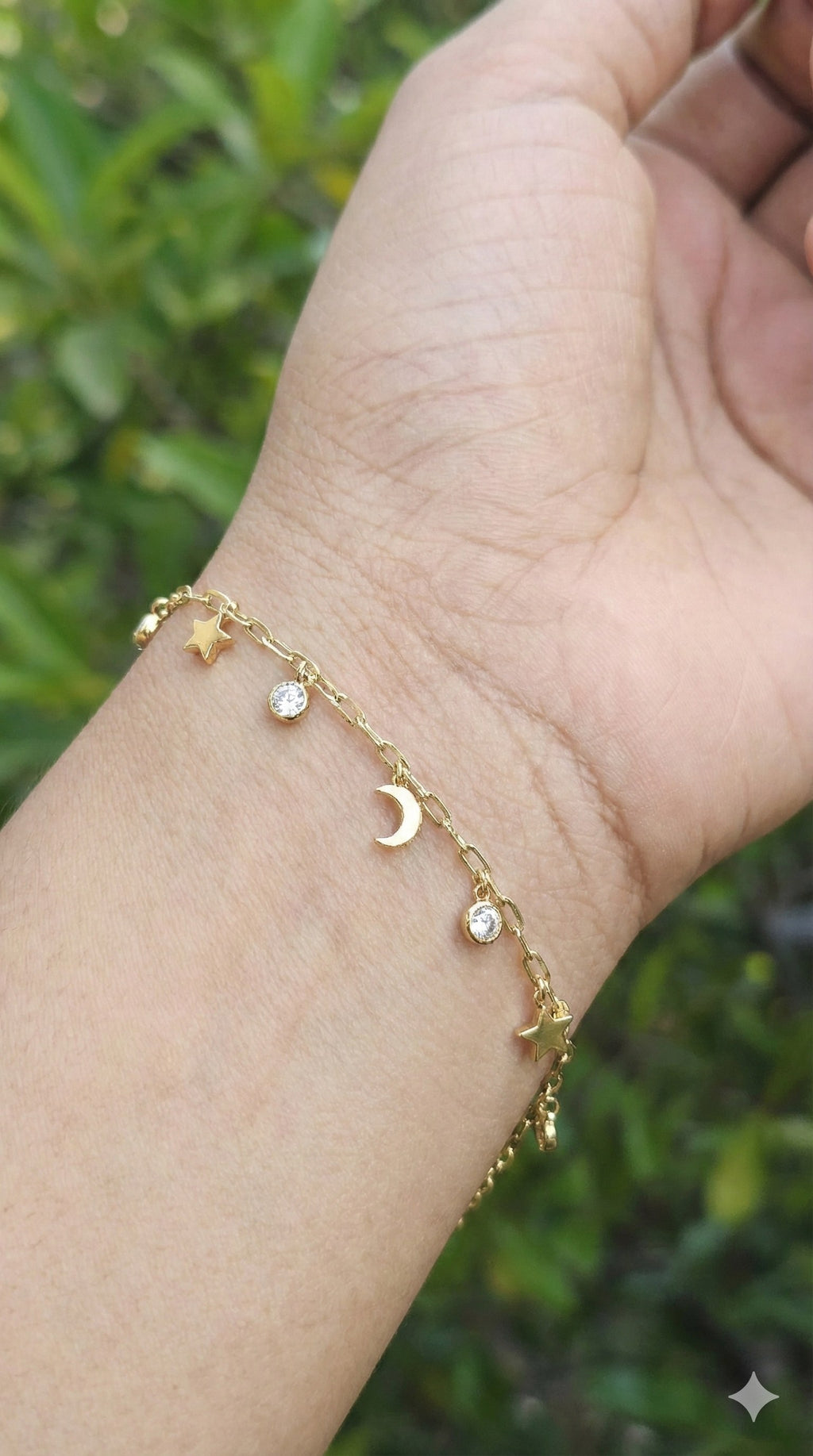 young woman wearing gold-plated hypoallergenic bracelet, showing their anti-tarnish shine suitable for sensitive skin and daily wear