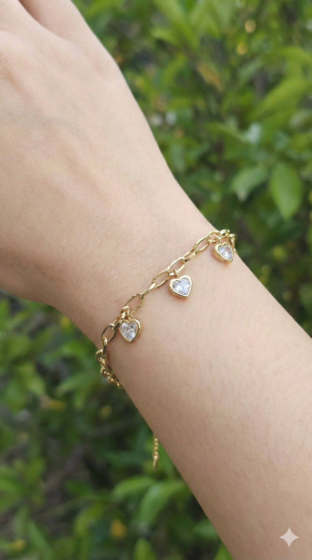 young woman wearing gold-plated hypoallergenic bracelet, showing their anti-tarnish shine suitable for sensitive skin and daily wear