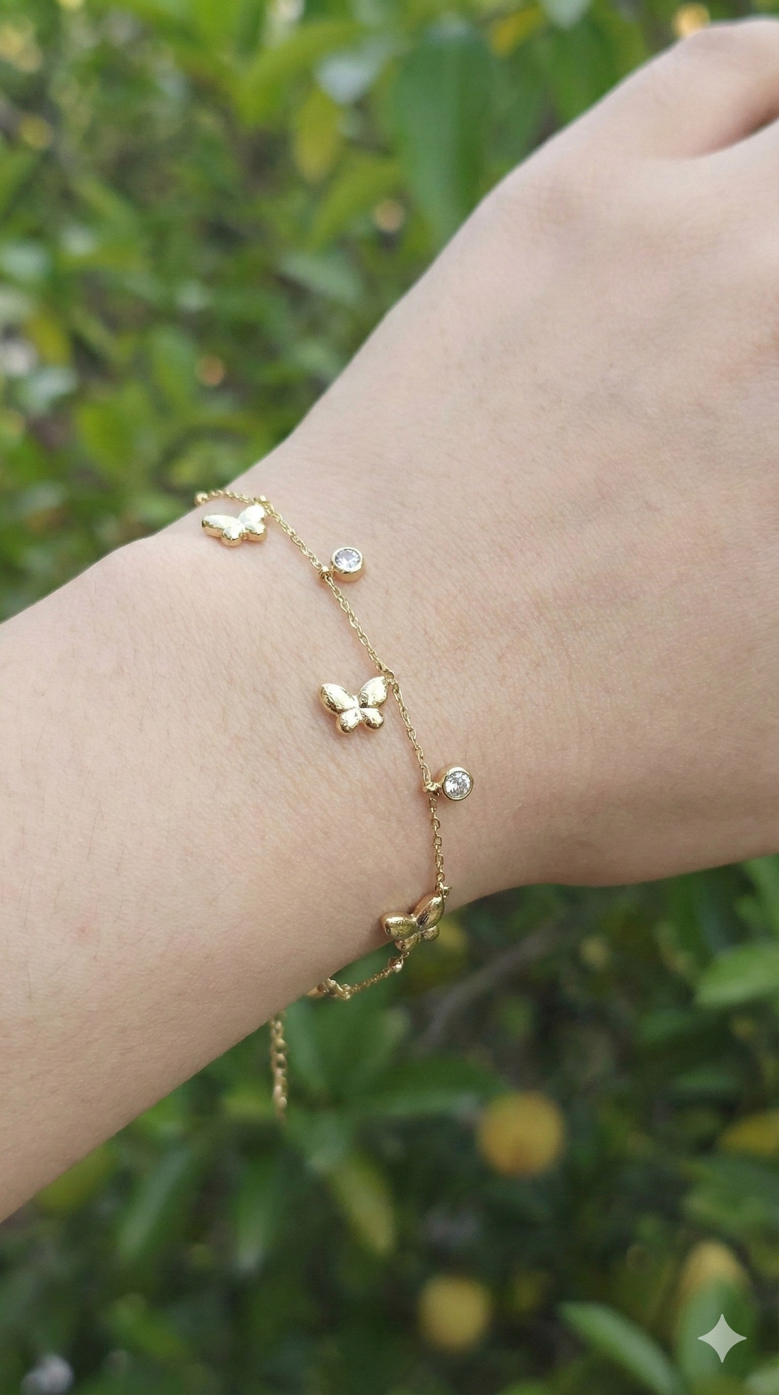 young woman wearing gold-plated hypoallergenic bracelet, showing their anti-tarnish shine suitable for sensitive skin and daily wear