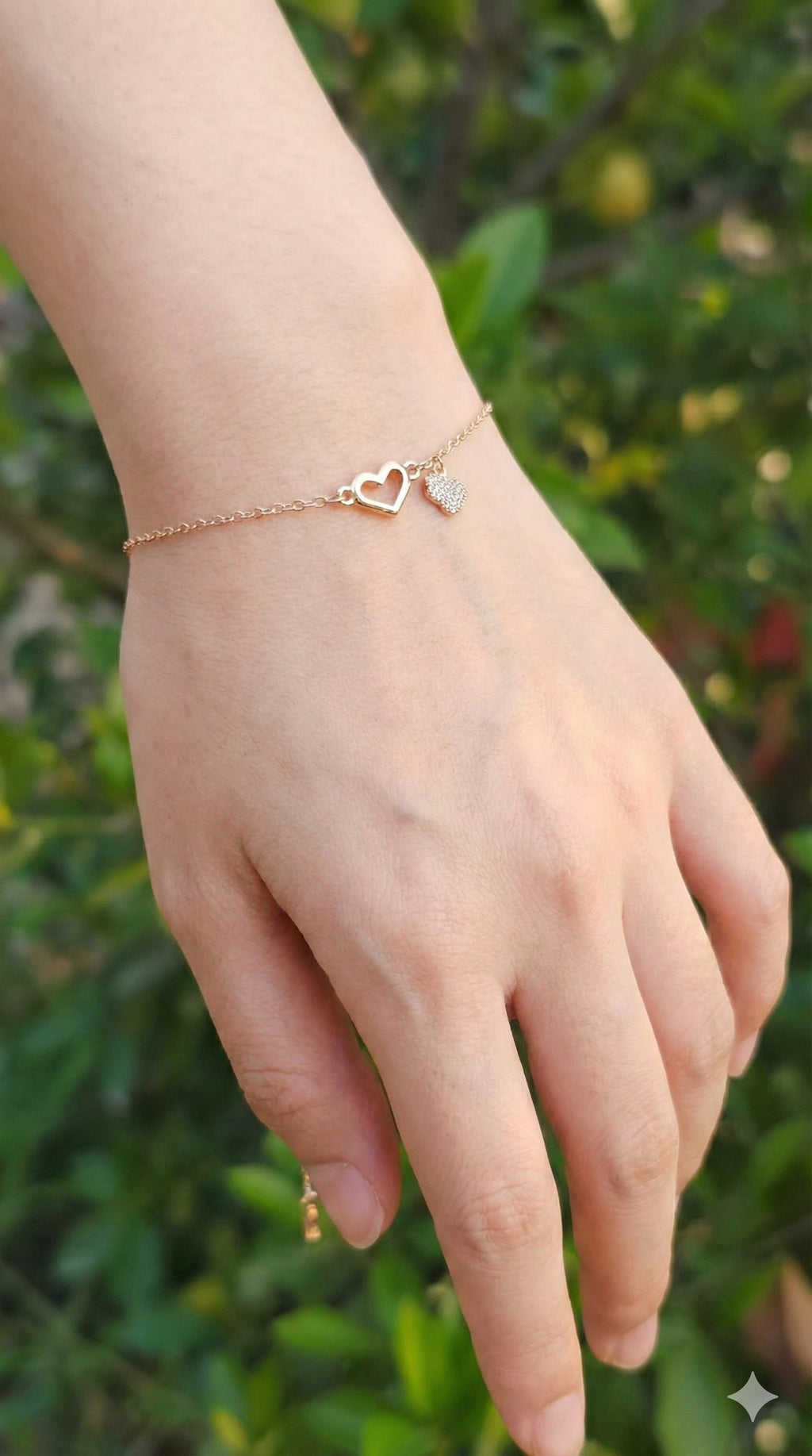 young woman wearing gold-plated hypoallergenic bracelet, showing their anti-tarnish shine suitable for sensitive skin and daily wear