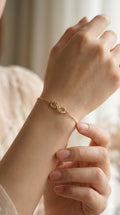 young woman wearing gold-plated hypoallergenic bracelet, showing their anti-tarnish shine suitable for sensitive skin and daily wear