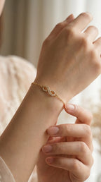 young woman wearing gold-plated hypoallergenic bracelet, showing their anti-tarnish shine suitable for sensitive skin and daily wear