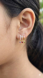 young woman wearing gold-plated hypoallergenic earrings, showing their anti-tarnish shine suitable for sensitive skin and daily wear