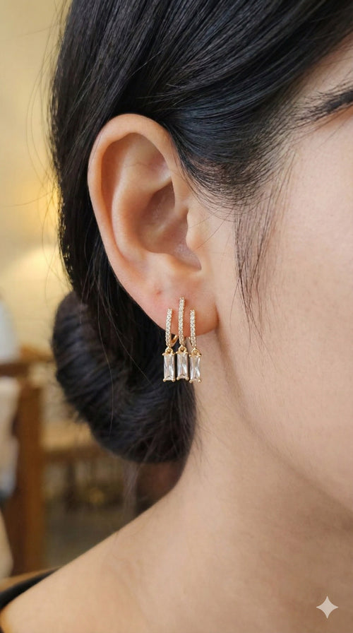 young woman wearing gold-plated hypoallergenic earrings, showing their anti-tarnish shine suitable for sensitive skin and daily wear