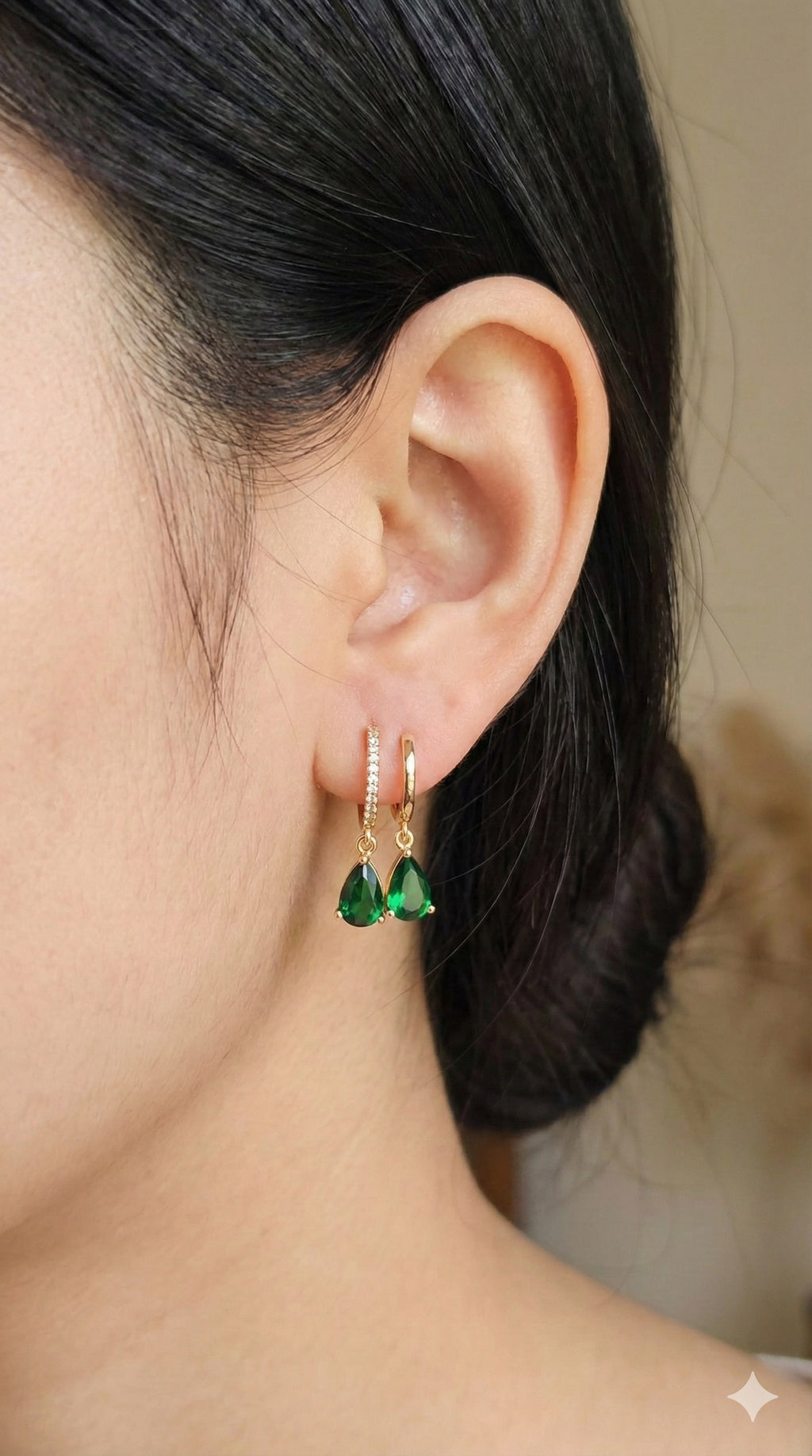 young woman wearing gold-plated hypoallergenic earrings, showing their anti-tarnish shine suitable for sensitive skin and daily wear