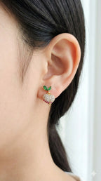 young woman wearing gold-plated hypoallergenic earrings, showing their anti-tarnish shine suitable for sensitive skin and daily wear