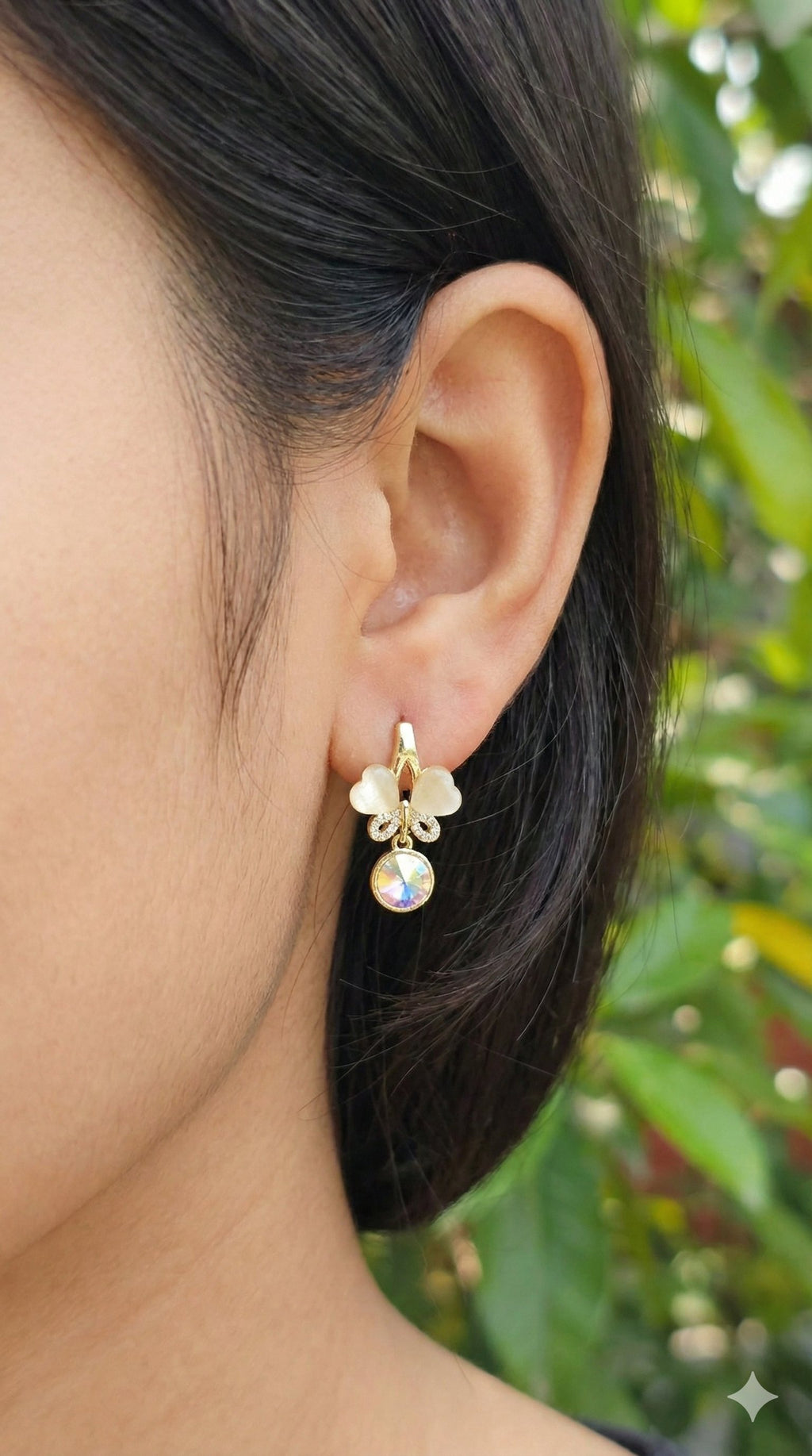 young woman wearing gold-plated hypoallergenic earrings, showing their anti-tarnish shine suitable for sensitive skin and daily wear